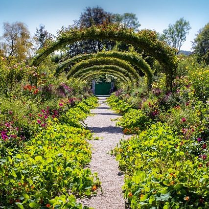 Atelier des Nymphéas entrance at Monet's Giverny estate with green timber frame and stone walls