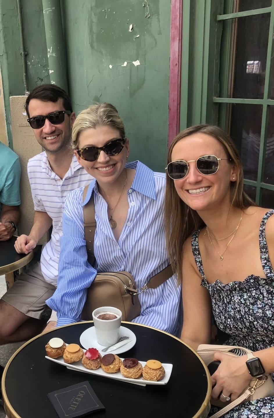 Happy tourists enjoying Paris cafe experience with Anja from Paris and Beyond Tours