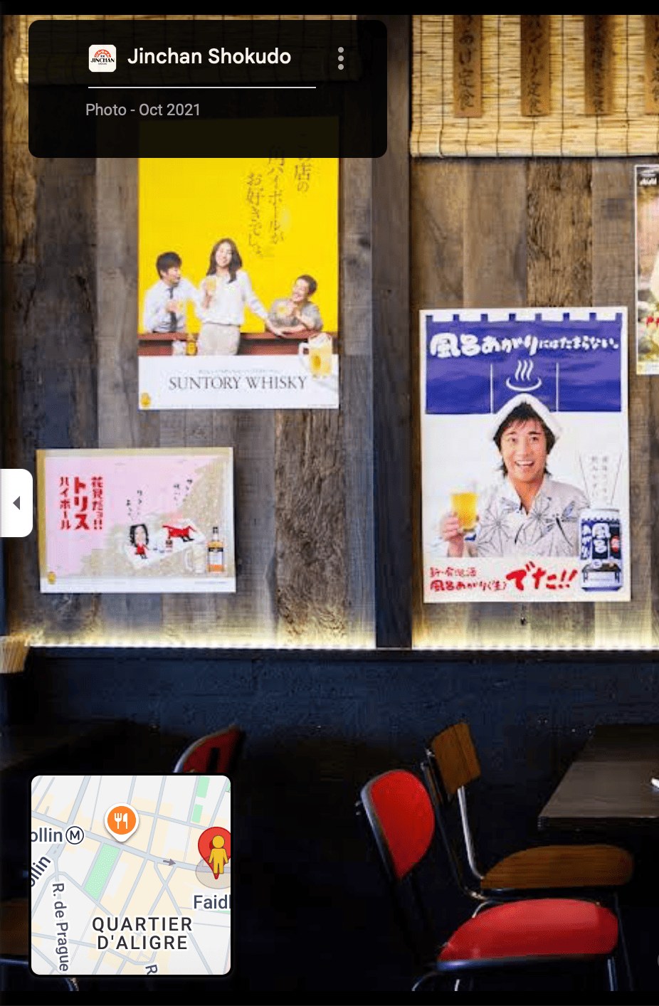 Vintage Japanese whisky advertisements on wooden wall at Jinchan Shokudo izakaya in Paris favourite restaurant of tour guide Sonja