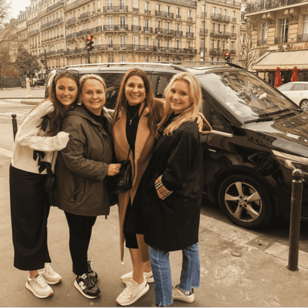 Four women beside Paris and Beyond Tours luxury van during Paris Your Way full-day private tour
