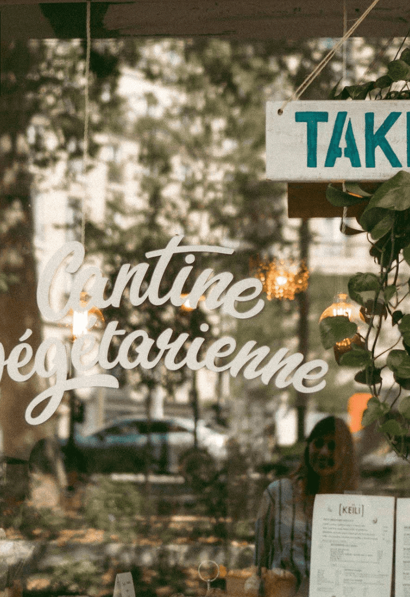 Keili vegetarian restaurant window on Rue Amelot Paris with cantine sign and outdoor terrace
