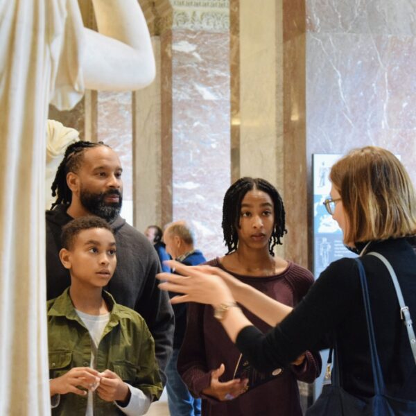 Paris and Beyond Tours expert guide explaining classical art to family with children during Louvre Museum scavenger hunt