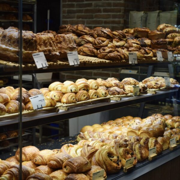 Trays filled with golden croissants and pastries in a Paris bakery, a tempting first stop on a private Marais food tour