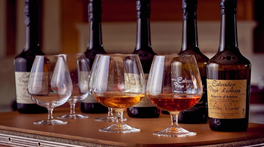 Calvados Pays d'Auge apple brandy tasting glasses bottles - Paris and Beyond Tours Normandy food tour from Bayeux Caen