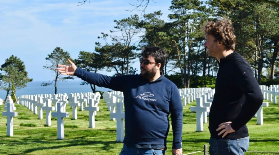 Paris and Beyond Tours expert guide explaining Normandy American Cemetery layout to guest with ocean view - private D-Day tour from Bayeux Caen