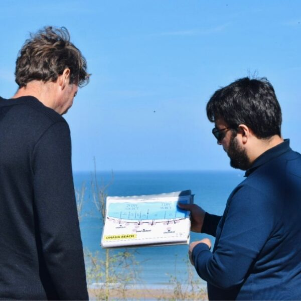 Paris and Beyond Tours guide explaining Omaha Beach D-Day tactical map to guest overlooking landing sectors - private WWII history tour from Bayeux Caen